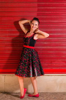 Woman posing with a vintage style retro floral clothing.