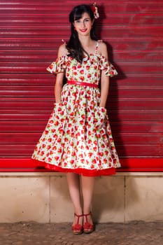 Woman posing with a vintage style retro floral clothing.