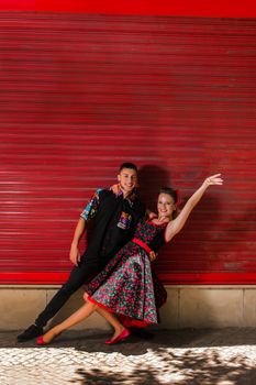 Vintage couple dancing over a red background.