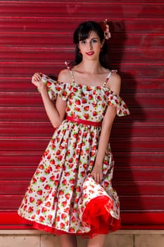 Woman posing with a vintage style retro floral clothing.