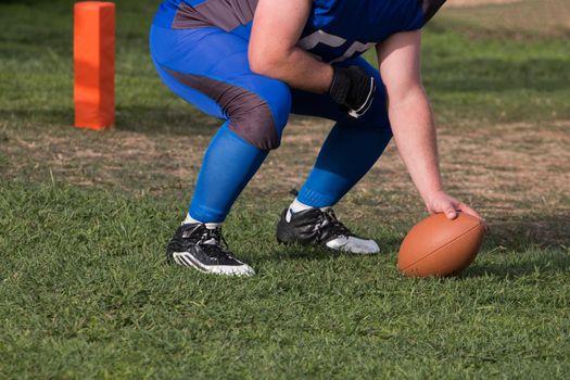 Close view of a American football player making a demonstration.