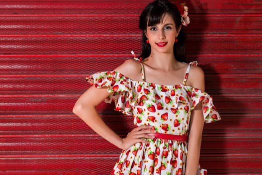 Woman posing with a vintage style retro floral clothing.