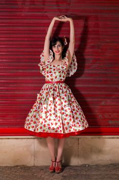 Woman posing with a vintage style retro floral clothing.