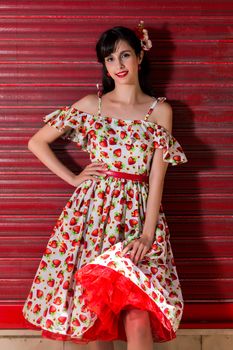 Woman posing with a vintage style retro floral clothing.