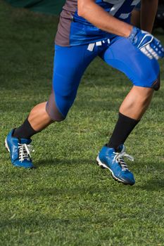 Close view of a American football player making a demonstration.