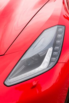 Close up view of a sports car headlight.
