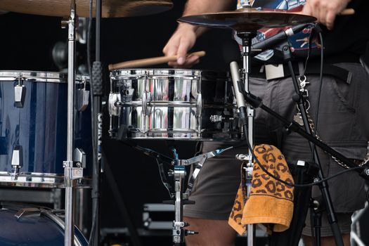 Close view detail of a drummer playing on a concert.