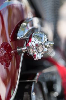 Close view detail of the shiny details of a classic motorcycle.