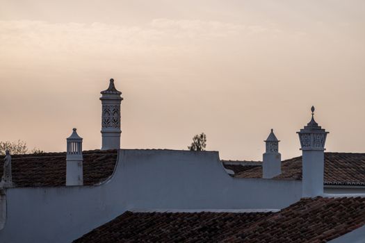typical chimneys on the rooftops  of the Algarve region.