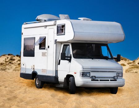 View of a camping caravan vehicle on the beach.