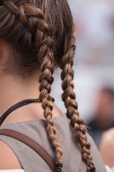 Close up view of a braided hairstyle on a girl.