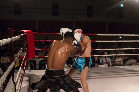Kickboxer in the ring fighting another athlete.