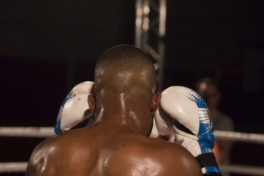 Kickboxer in the ring fighting another athlete.