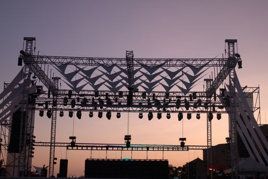 Projector lights section view of a stage for music concert.