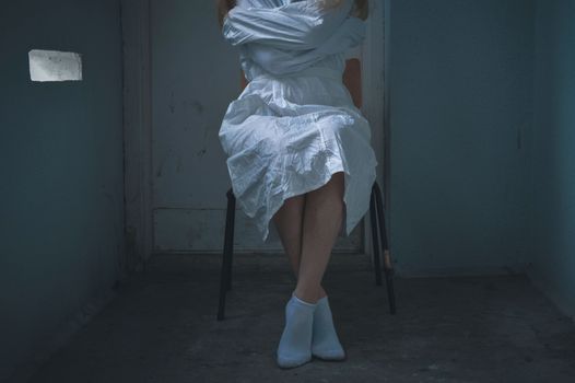 mentally ill girlwith a straitjacket in a Psychiatric