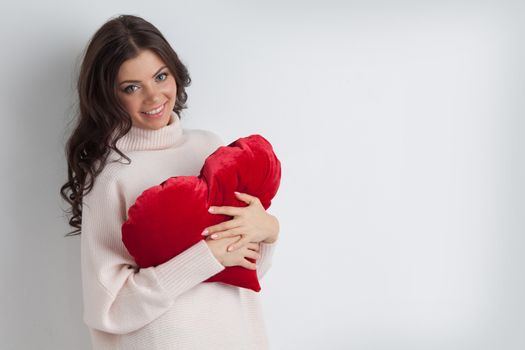 Beautiful woman with red pillow heart, valentine's day concept