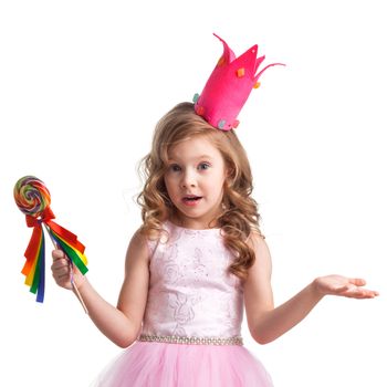 Beautiful little candy princess girl in crown holding big lollipop and posing with hands up in air saying, why, i dont know, so what