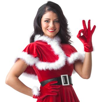 Woman in red Santa Claus outfit showing ok sign