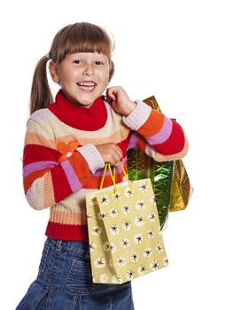 Smiling six years Girl holding presents bags isolated