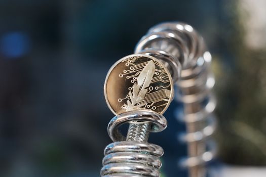 Gold feather coin on the faucet