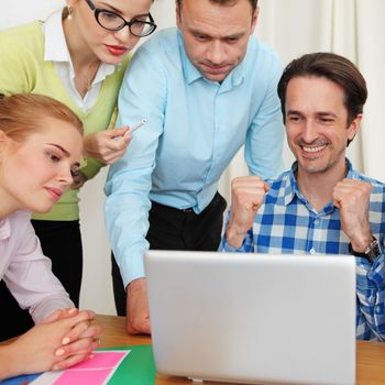 Business team work together looking at one laptop at workplace