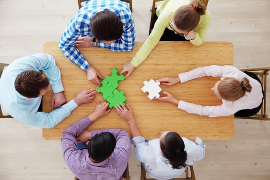 Hipster business successful teamwork concept, business people group assembling jigsaw puzzle, top view