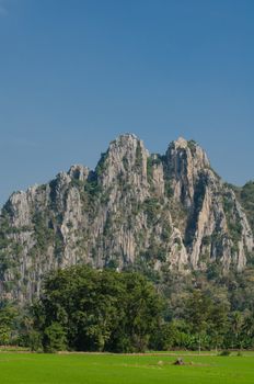 Kao Nor Kao Kawg is limestone mountain in Nakon sawan Province and have green paddy ,blue sky