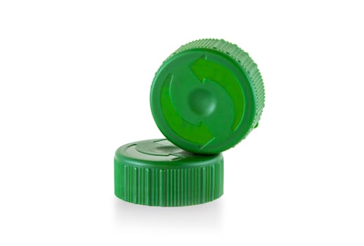 Two green plastic bottle caps isolated on white