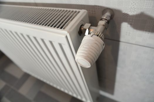 white heating radiator under in the room
