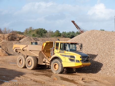 parked yellow quarry tipping truck construction big wheels; essex; england; uk