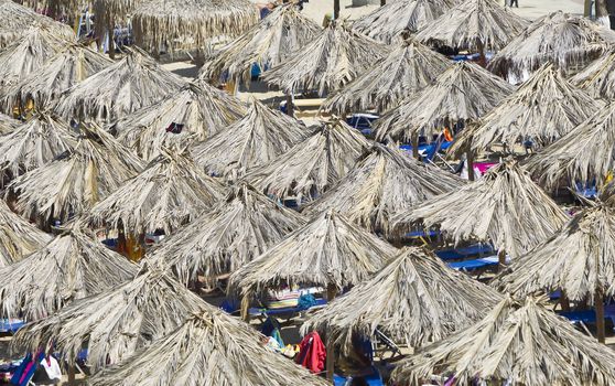 Beach with straw umbrellas in Greece, Chalkidiki, Sithonia.