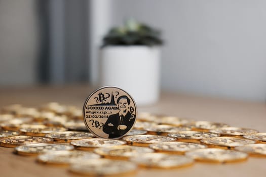 Digital currency physical metal bitcoin coin on the gold money background. Money concept.