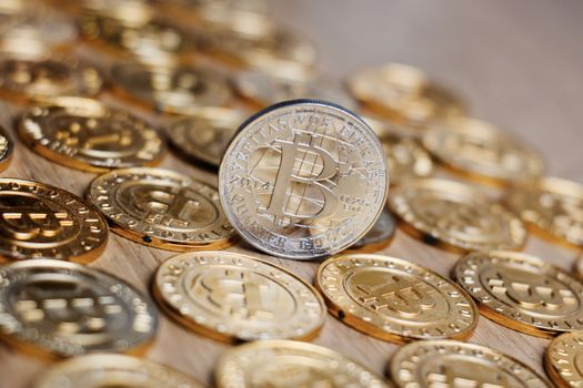 Digital currency physical metal bitcoin coin on the gold money background. Money concept.