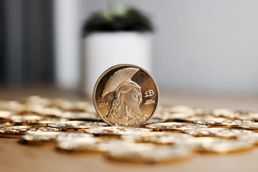 Digital currency physical metal bitcoin coin on the gold money background. Money concept.