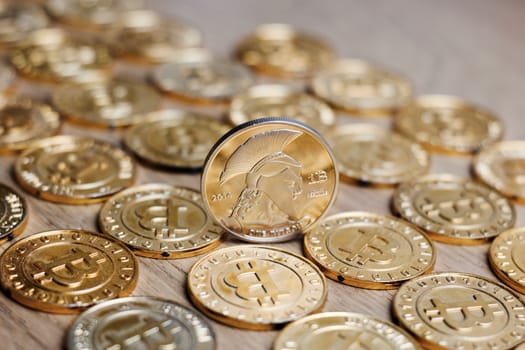 Digital currency physical metal bitcoin coin on the gold money background. Money concept.