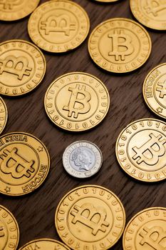 Digital currency physical metal bitcoin coin on the gold money background. Money concept.