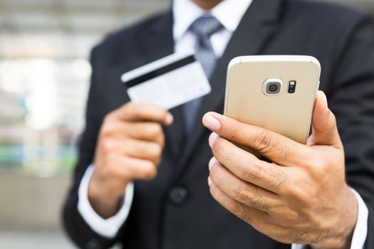 businessman hands holding credit card and using phone. Online shopping purchase Sell or Payment.