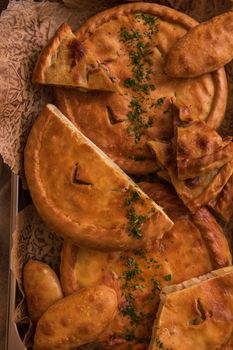 Different pies from meat and vegetables. Freshly baked cakes on a table