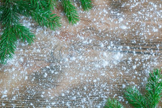 Christmas and New Year winter holiday snowbound wooden background with green fir tree branches