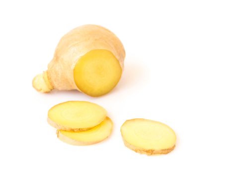 Fresh ginger with slices on white background for herb and medical product concept, selective focus