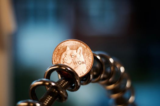 Digital currency physical brass dogecoin coin. Cryptocurrency mining concept.
