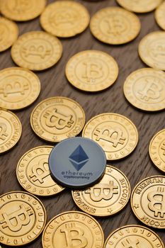 Digital currency physical metal bitcoin coin on the gold money background. Money concept.