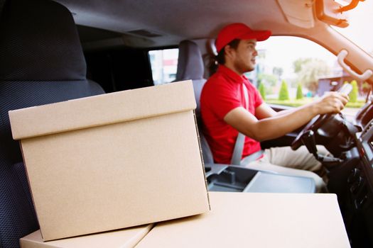 delivery service courier ringing the house doorbell with boxes in hands