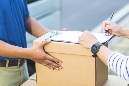 delivery of a package through a service. hand accepting a delivery of boxes from deliveryman. All services are impressive.