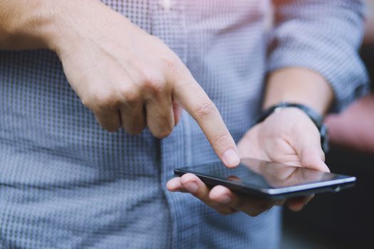 close up of Young Man using mobile smart phone.