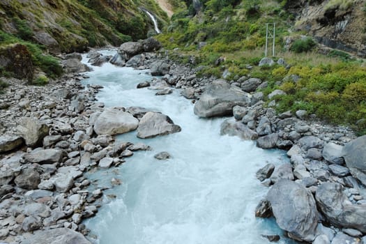 Rapids and waterfall in the narrow place of the mountain river in the Himalayas 