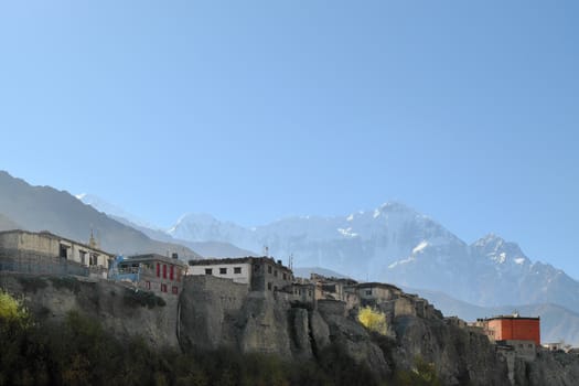 Mountain village in the Himalayas with the eight-thousand-meter Dhaulagiri in the background