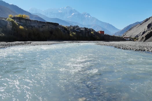 Mountain river in the Himalayas with the eight-thousand-meter Dhaulagiri in the background