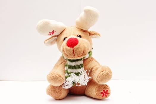 Soft toy merry Christmas deer on a white background.