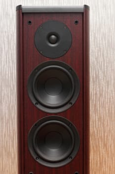 Acoustic wooden sound system with three speakers on the gray background.